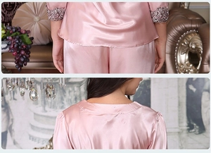 Detail of pink satin pajama set featuring delicate lace cuffs and smooth silk texture