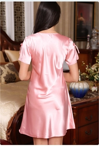 Pink satin short sleeve nightgown featuring elegant bow details and silky draped fabric