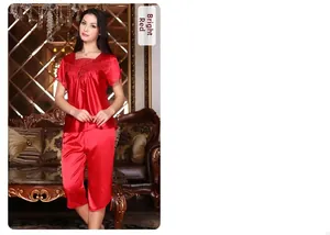 Detail of red silk pajama set featuring delicate lace embroidery on the neckline