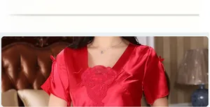 Detail view of red silk nightdress with V-neck lace embroidery and bow-knot sleeve design