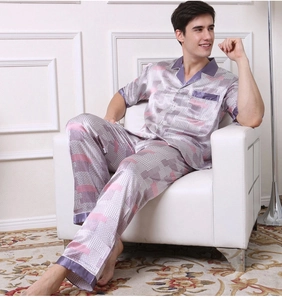 Detail of men's satin pajama set featuring geometric plaid pattern and purple piping