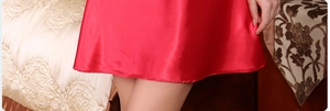 Detailed view of the red satin nightgown hem showing high-quality silk texture and stitching