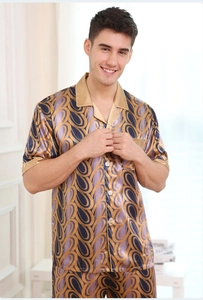 Detail of men's satin pajama set with luxury paisley pattern and golden silk trims