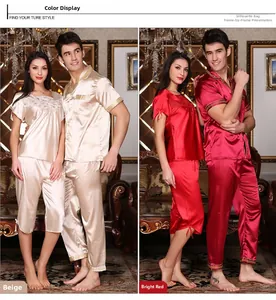 Detail of silk pajamas in beige and red featuring elegant gold embroidery trims