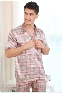Detailed view of men's silk-like pajamas with geometric patterns and contrast piping