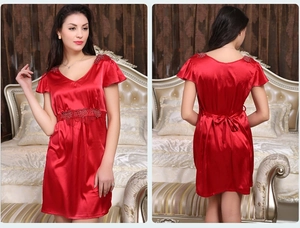 Detail of red satin nightdress showing V-neck lace embroidery and back bow tie design