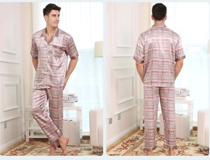 Close-up of men's satin pajama set featuring grey and pink geometric grid patterns