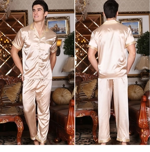 Detail of champagne gold silk pajamas with intricate gold embroidery on cuffs and lapels
