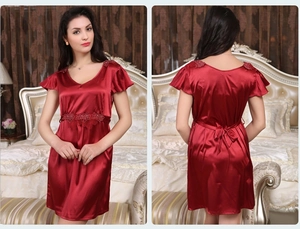 Detail of burgundy satin nightgown featuring lace embroidery and back tie fastening