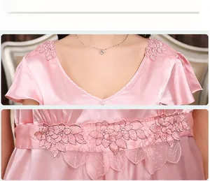 Detailed view of pink silk satin sleepwear featuring V-neck and delicate leaf embroidery