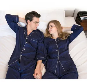 Close-up of deep blue satin pajama collar with white piping and vertical stripe texture