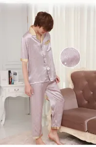 Detailed texture of circular grey silk satin pajamas set with intricate ring patterns