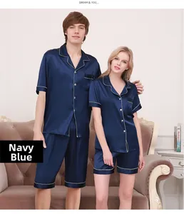 Detail of navy blue silk pajama sets for couples with white contrast piping and buttons