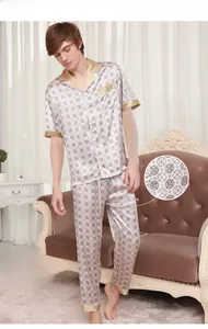 Detail of men silk pajamas with gold piping and four-leaf clover pattern print