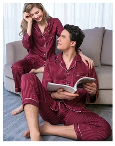 Close-up of burgundy satin pajama detail showing white piping and vertical jacquard stripes