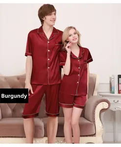 Detail of wine red silk satin pajamas with white piping and classic button-up design