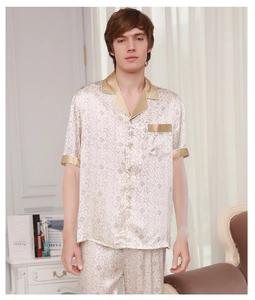 Detail of premium champagne silk pajamas featuring intricate floral print and satin trim