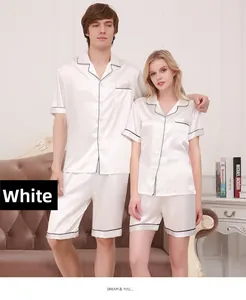 Detail of white silk pajamas set with black piping on lapel and chest pocket design