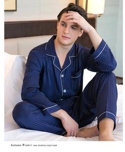 Detail of navy blue silk pajamas for men featuring vertical stripes and white piping trim