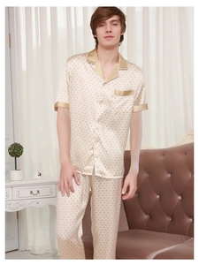 Close-up of silk pajamas featuring a diamond print and golden satin trim details