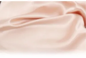 Detailed view showing the smooth texture and drape of glossy pink satin pajamas fabric