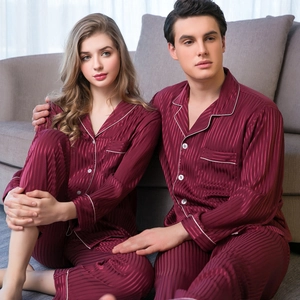 Matching burgundy silk satin pajama set for couples with vertical stripes and white piping