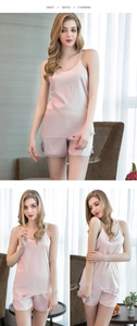 Detail of pink silk-like satin pajama set with camisole top and bow-accented shorts