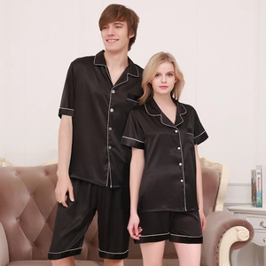 Lustrous black silk satin pajama set for couples featuring short sleeves and white piping