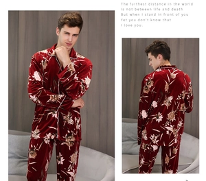 Detailed view of burgundy velvet men's pajamas with elegant floral pattern and white piping