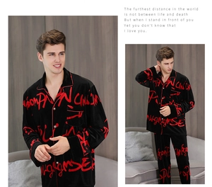 Detailed view of men's black velvet pajamas with red graffiti print and piped lapel collar