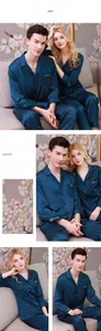 Close-up of silk couple pajamas with gold Harmony embroidery on deep blue-green fabric