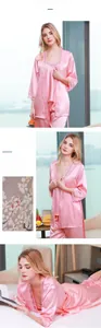 Three-piece pink silk pajama set featuring a lace-trimmed robe, camisole, and pants