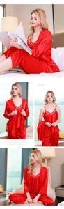Detail of red silk sleepwear robe with delicate lace trim on sleeves and neckline