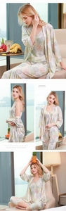 Detailed view of women's 3-piece silk pajama set with green leaf print on robe and pants