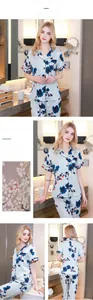 Detail of short sleeve silk pajamas with plum blossom print and black piping trim