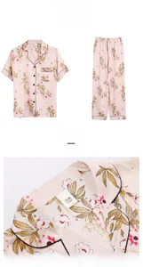 Close-up of pink floral satin pajama top featuring a lapel collar and black piping detail