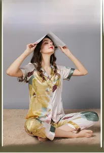 Detail of silk-like floral pajamas with soft texture and vibrant print on model