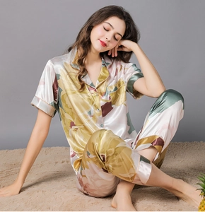 Detail of floral print satin pajama set with short-sleeved shirt and matching long pants