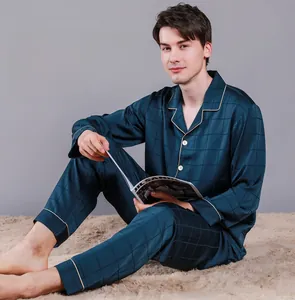 Detail of navy blue plaid silk pajamas showing lapel collar and piped button closure