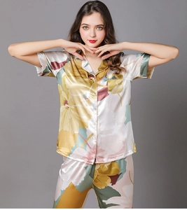 Detail of silk-satin pajama set featuring abstract floral print and notched lapels