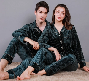 Detail of dark green velvet couple pajamas with diamond patterns and contrast piping