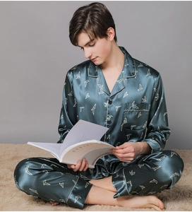 Detail of dark blue silk satin pajamas with geometric prints and contrast piping trim