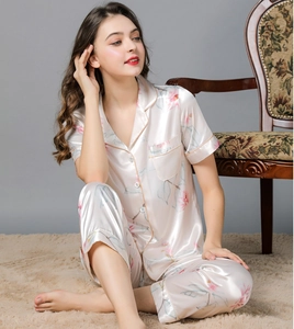 Detail of floral silk pajama set featuring short sleeves and satin finish material
