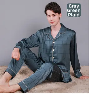 Detail view of grey-green plaid silk pajamas featuring contrast beige piping on sleeves
