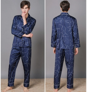 Detail of men's dark blue satin silk pajama set with white laser line prints and piping