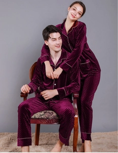 Detail of burgundy velvet pajamas with diamond quilted texture and white piping