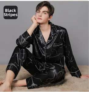 Close-up of men's black silk pajamas featuring white laser line patterns and satin sheen