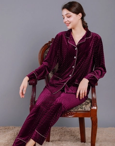 Close-up of wine red velvet pajama set with diamond pattern embossing and white piping