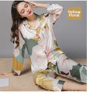 Detail of silk-like long-sleeve pajamas with yellow large floral print on satin fabric