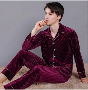 Macro shot of men's burgundy velvet pajamas with quilted diamond texture and white piping